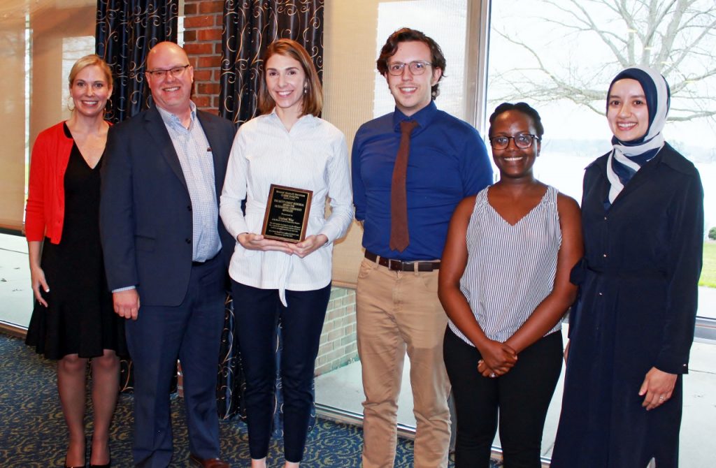 SAS Systems Manager Danielle Kostrab (left) presents the Betty Christ Memorial Award to United Way BCKR's Chris Sargent, Alyssa Stewart, Ian Magnuson, Irene Muthui, and Bayane Alem.