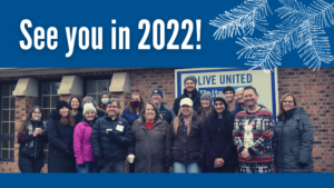 Photo of staff members in front of Kalamazoo office, with text: See you in 2022!