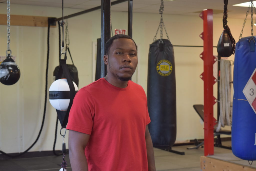 Jermont Reece of Kzoo Boxing stands inside his establishment filled with boxing equipment.